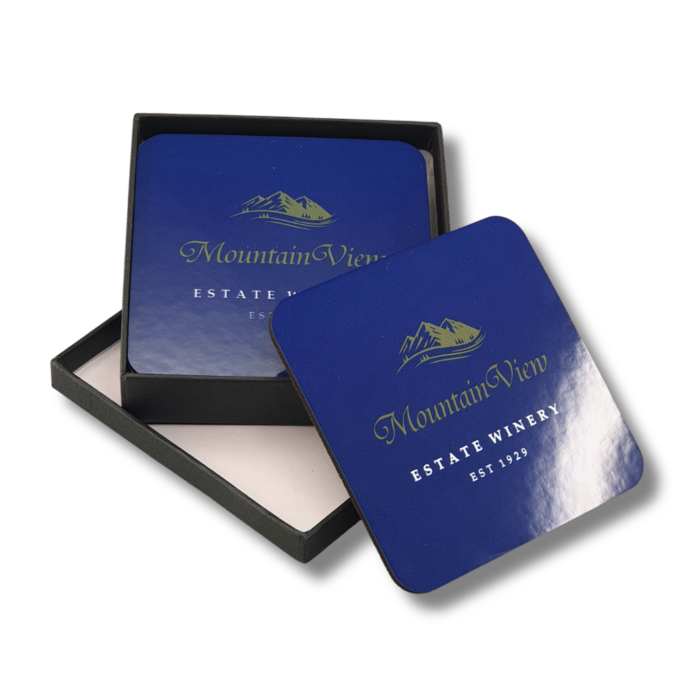 branded-mdf-cork-coaster-gift-set-winery Branded square MDF drink coasters featuring Mountain View Estate Winery logo in gold and white on blue, presented in a black gift box.